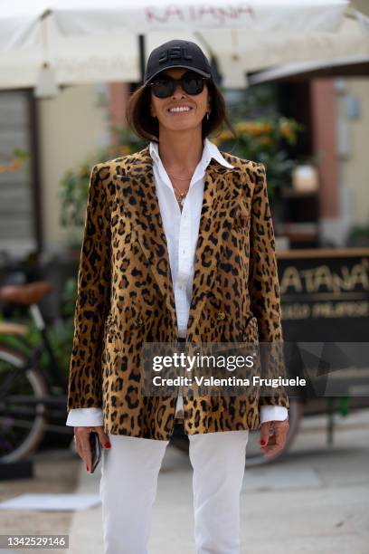 Viviana Volpicella outside MSGM fashion show wearing a leopard print jacket, white pants and baseball cap during the Milan Fashion Week - Spring /...