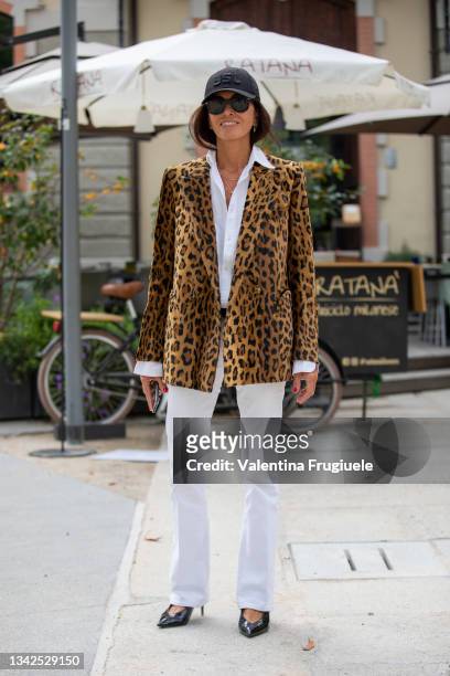 Viviana Volpicella outside MSGM fashion show wearing a leopard print jacket, white pants and baseball cap during the Milan Fashion Week - Spring /...