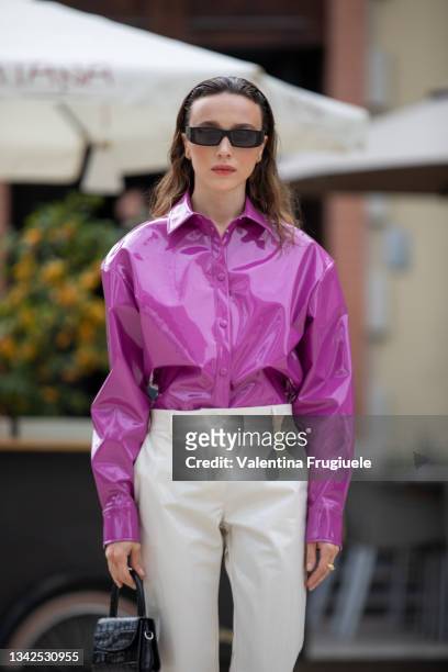 Mary Leest outside MSGM fashion show wearing purple button shirt, creme white pants and black micro bag during the Milan Fashion Week - Spring /...