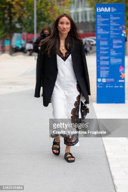 Guest outside MSGM fashion show wearing a white nightgown dress during the Milan Fashion Week - Spring / Summer 2022 on September 25, 2021 in Milan,...