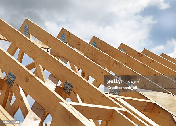 construction of a wooden roof frame underway - framework stock pictures, royalty-free photos & images