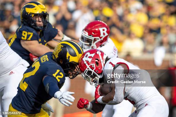Linebacker Josh Ross of the Michigan Wolverines tackles running back Isaih Pacheco of the Rutgers Scarlet Knights in the second quarter at Michigan...