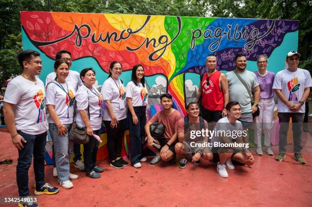Joy Belmonte, mayor of Quezon City, center, poses for a photo at the freedom wall during the Pride march and festival in Quezon City, Philippines, on...