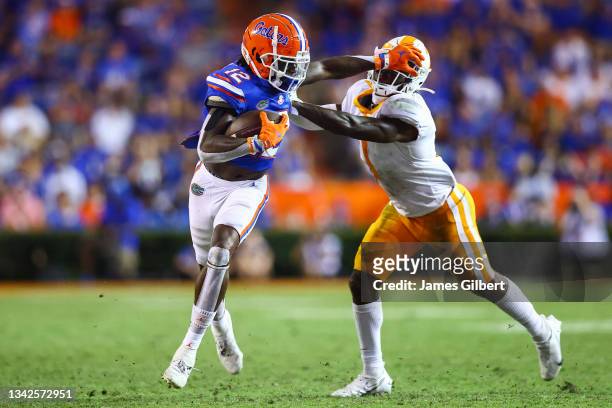 Rick Wells of the Florida Gators runs for yardage against Trevon Flowers of the Tennessee Volunteers during the fourth quarter of a game at Ben Hill...