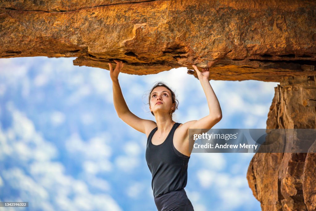Girl Looking Over Rocks Woman Rock Climber Looking Up Under Cliff Overhang High-Res Stock Photo ...