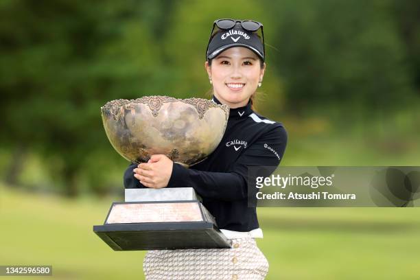 Yuna Nishimura of Japan poses with the trophy after winning the tournament following the final round of the Miyagi TV Cup Dunlop Ladies Open at Rifu...