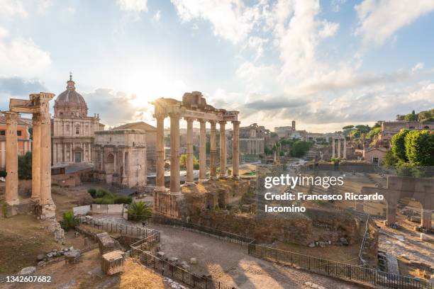 fori imperiali (roman forum), ruins of the ancient roman empire and coliseum on background. rome, lazio, italy - roman forum foto e immagini stock