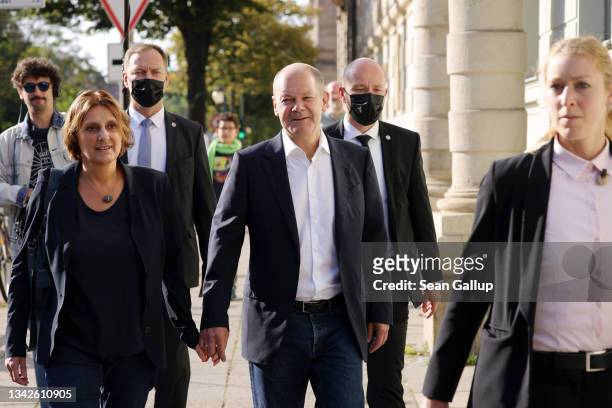 Olaf Scholz, chancellor candidate of the German Social Democrats , and his wife Britta Ernst arrive to cast his ballot in federal parliamentary...