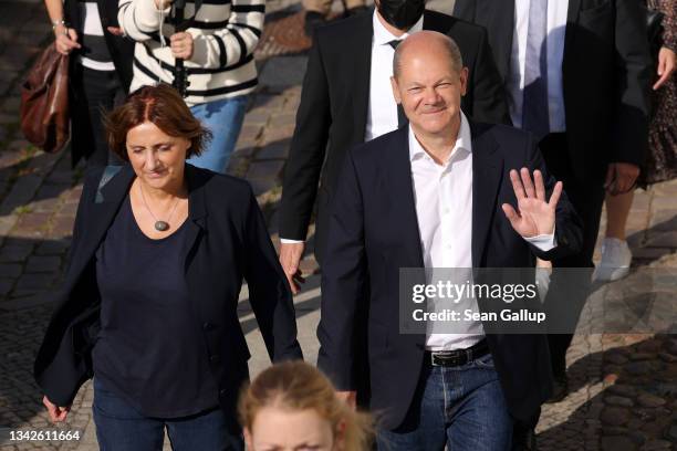 Olaf Scholz, chancellor candidate of the German Social Democrats , and his wife Britta Ernst leave after casting their ballots in federal...