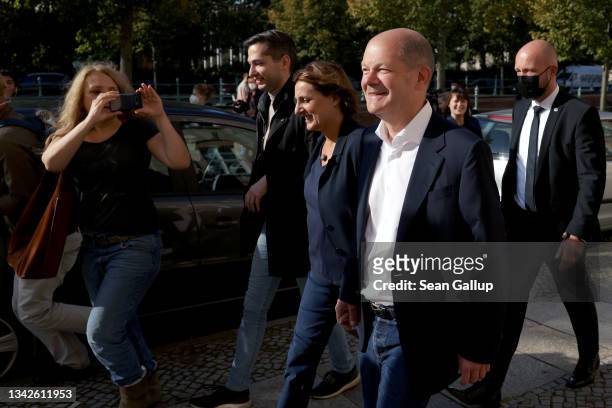 Olaf Scholz, chancellor candidate of the German Social Democrats , and his wife Britta Ernst leave after casting their ballots in federal...