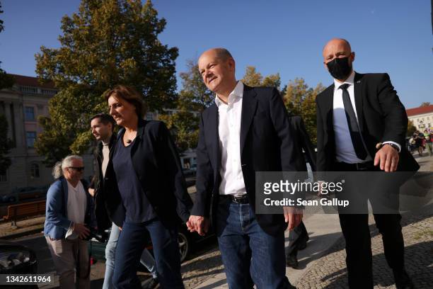 Olaf Scholz, chancellor candidate of the German Social Democrats , and his wife Britta Ernst leave after casting their ballots in federal...