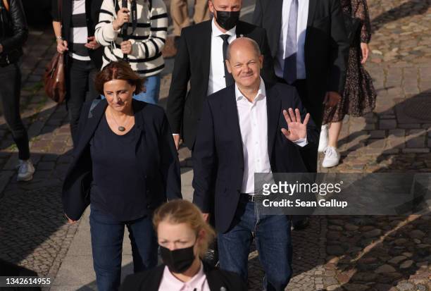 Olaf Scholz, chancellor candidate of the German Social Democrats , and his wife Britta Ernst depart after casting their ballots in federal...