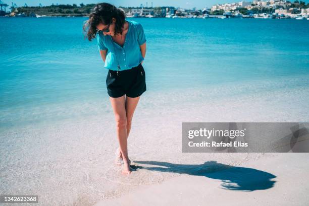 beautiful elegant woman standing at the shore looking down - down blouse imagens e fotografias de stock