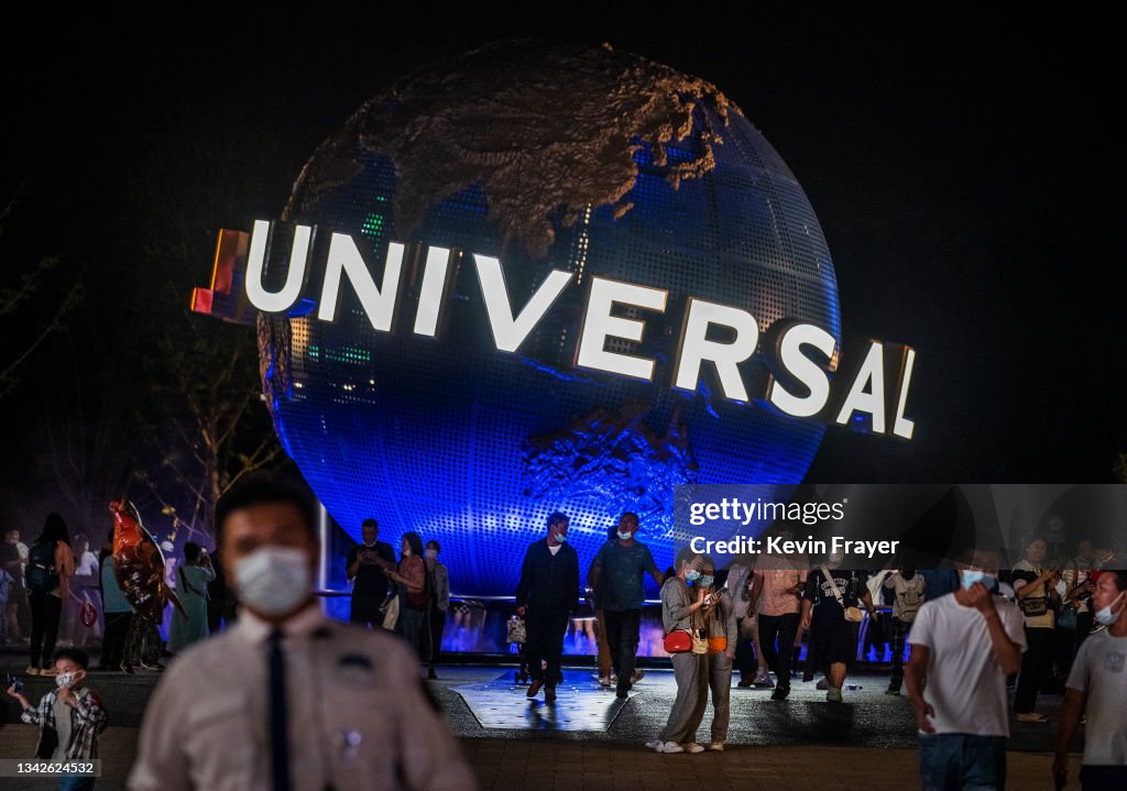 China Universal Rides People walk in front of the trademark globe at Universal Studios ...