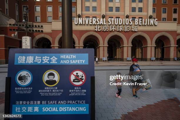 Sign shows COVID-19 epidemic control measures at the entrance of Universal Studios Beijing on September 23, 2021 in Beijing, China. Universal Studios...