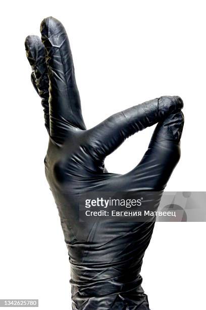 woman's hand in black glove show okay gesture isolated on white background. medicine, beauty, cleaning - black glove stock pictures, royalty-free photos & images