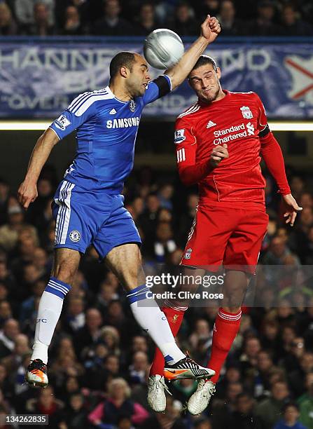 Alex of Chelsea gives away a hand ball leading to a penalty under a challenge by Andy Carroll of Liverpool during the Carling Cup quarter final match...