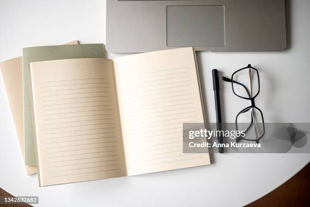 directly above shot of office desk and stationery on white background - phone still life stock pictures, royalty-free photos & images