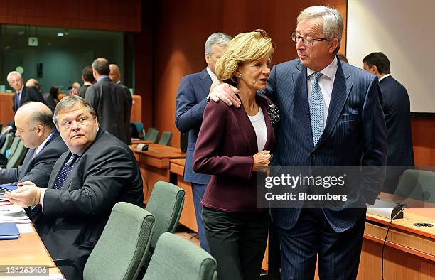 Jean-Claude Juncker, Luxembourg's prime minister and president of the Eurogroup, right, speaks with Elena Salgado, Spain's finance minister, center,...