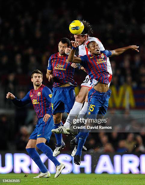 Miguel Perez 'Michu' of Rayo Vallecano duels for a high ball with Javier Mascherano of FC Barcelona and Seydou Keita of FC Barcelona during the La...