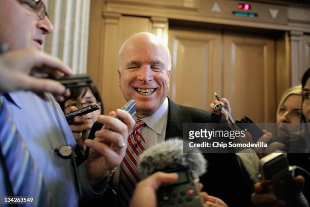 Senate Armed Services Committee ranking member U.S. Sen. John McCain talks with reporters as he leaves the weekly Senate Republican policy luncheon...