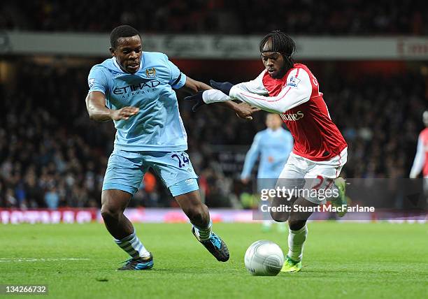 Gervinho of Arsenal takes on Nedum Onuoha of Manchester City during the Carling Cup Quarter Final match between Arsenal and Manchester City at...