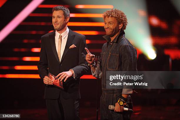 Host Jochen Schropp and Rufus Martin listen to the jury during 'The X Factor Live' Semifinal TV-Show on November 29, 2011 in Cologne, Germany.