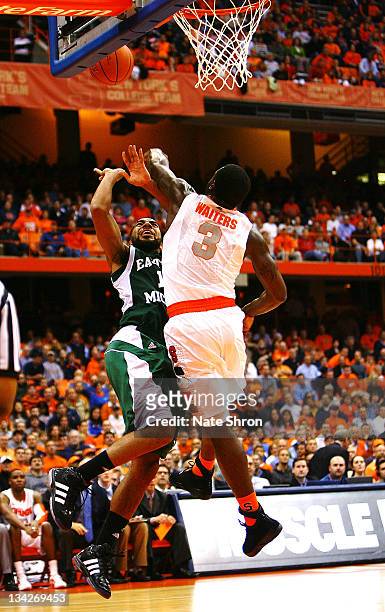 Dion Waiters of the Syracuse Orange blocks the shot of Antonio Green of the Eastern Michigan Eagles during the game at the Carrier Dome on November...