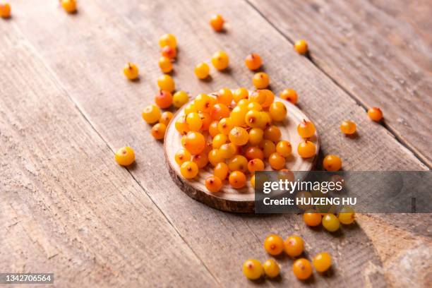 seabuckthorn berries on wooden background - buckthorn stock pictures, royalty-free photos & images