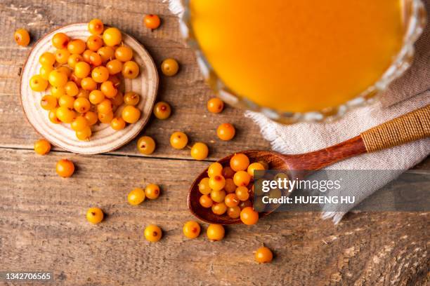 fresh ripe orange sea buckthorn berries vitamin juice in a glass jar - buckthorn stock pictures, royalty-free photos & images