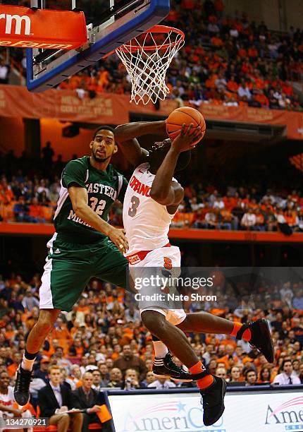 Dion Waiters of the Syracuse Orange drives to the basket against Jamell Harris of the Eastern Michigan Eagles during the game at the Carrier Dome on...