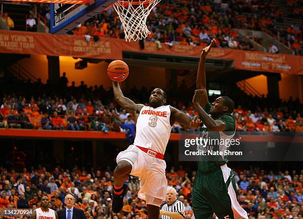 Dion Waiters of the Syracuse Orange drives to the basket against Anthony Strickland of the Eastern Michigan Eagles during the game at the Carrier...