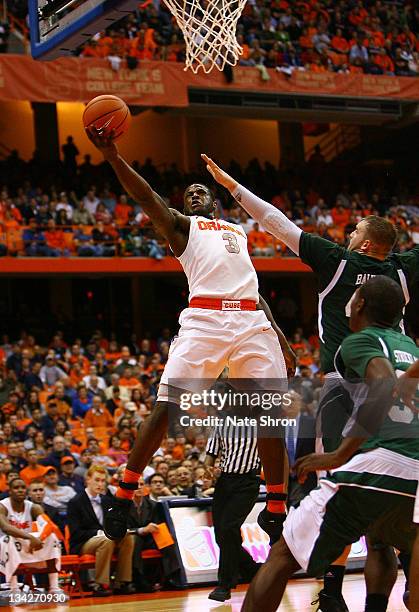 Dion Waiters of the Syracuse Orange reaches to the basket against Matt Balkema of the Eastern Michigan Eagles during the game at the Carrier Dome on...