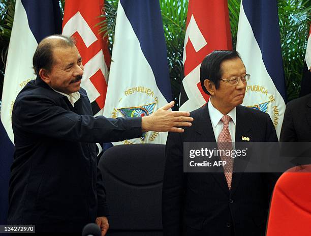 Taiwan Foreign Minister Timothy Chin-tien Yang stands with Nicaraguan President Daniel Ortega following a meeting at the ''La casa de los Pueblos''...