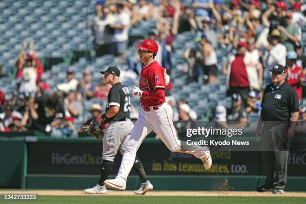 Shohei Ohtani of the Los Angeles Angels rounds the bases after hitting a two-run home run during the ninth inning of a baseball game against the...