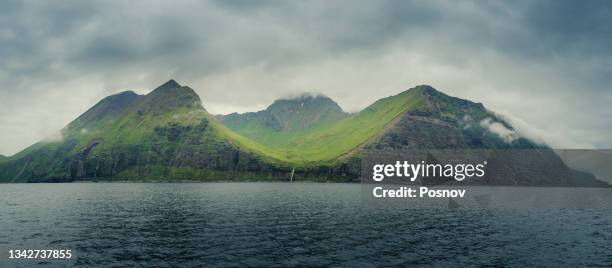 sea cliffs and waterfall of unalaska, - bering sea fotografías e imágenes de stock