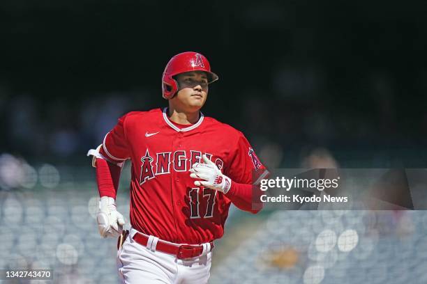 Shohei Ohtani of the Los Angeles Angels rounds the bases after hitting a two-run home run during the ninth inning of a baseball game against the...