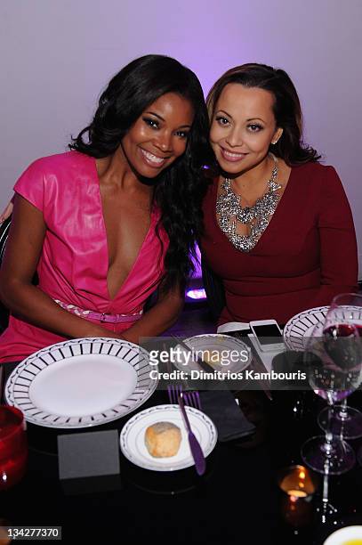 Gabrielle Union and Adrienne Bosh attend the Dior pop-up shop featuring Anselm Reyle for Dior at Miami Design District on November 29, 2011 in Miami...