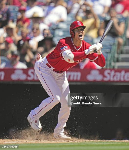 Shohei Ohtani of the Los Angeles Angels reacts to a pitch that landed near his foot during the seventh inning of a baseball game against the Chicago...