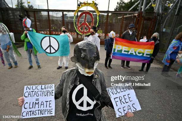 Activists hold a die-in protest at the North Gate of Her Majesty's Naval Base, Clyde on September 26, 2021 in Faslane, Scotland. HMNB Clyde is the...