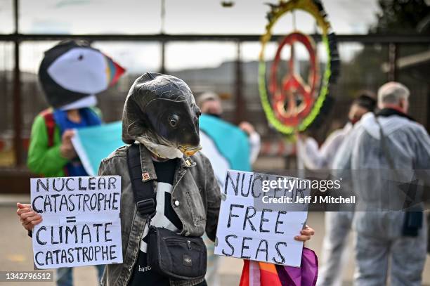 Activists hold a die-in protest at the North Gate of Her Majesty's Naval Base, Clyde on September 26, 2021 in Faslane, Scotland. HMNB Clyde is the...