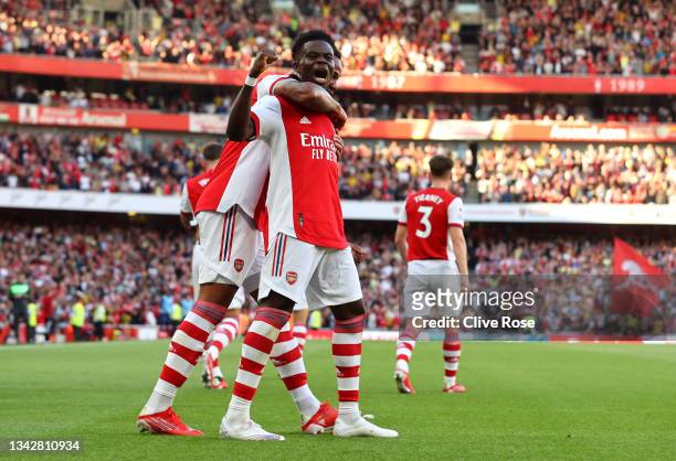 Bukayo Saka of Arsenal celebrates after scoring their side's third goal during the Premier League match between Arsenal and Tottenham Hotspur at...