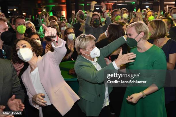 Members of the German Greens Party react to initial results at the Columbiahalle venue in federal parliamentary elections on September 26, 2021 in...