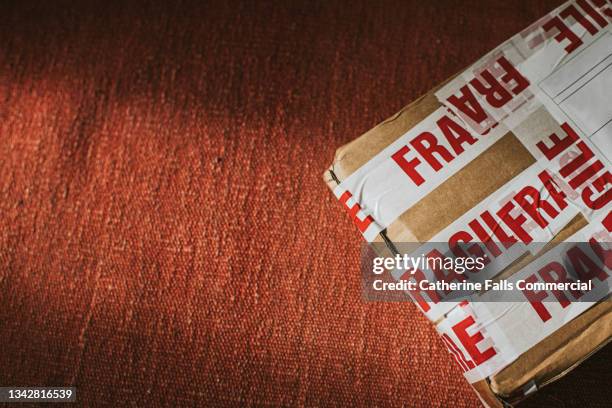 a package covered in fragile warning tape - damaged parcel stock pictures, royalty-free photos & images