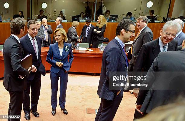 Left to right, Francois Baroin, France's finance minister, Mario Draghi, president of the European Central Bank , Elena Salgado, Spain's finance...