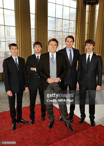 Roxy Music lead singer Bryan Ferry poses with his four sons Merlin, Isaac, Otis, and Tara as they arrive for an Investiture Ceremony at Buckingham...