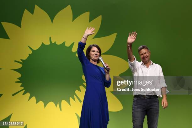 Annalena Baerbock , chancellor candidate of the German Greens Party, and Robert Habeck, co-leader of the German Greens Party, react to initial...