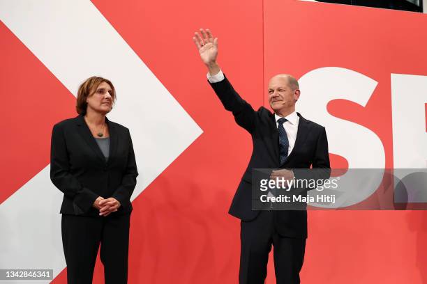 Olaf Scholz , chancellor candidate of the German Social Democrats , waves to supporters next to his wife Britta Ernst in reaction to initial results...