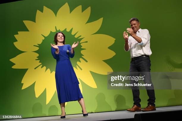 Annalena Baerbock , chancellor candidate of the German Greens Party, and Robert Habeck, co-leader of the German Greens Party, applaud in reaction to...