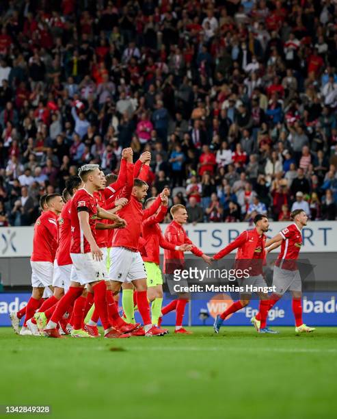 Players of Freiburg celebrate after the Bundesliga match between Sport-Club Freiburg and FC Augsburg at SC-Stadion on September 26, 2021 in Freiburg...